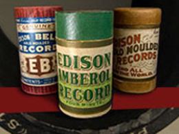 three cylinders with words Edison on front of one in middle